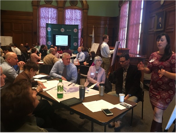 A small group facilitator leads discussion at a small table during the Worcester Municipal Vulnerability Preparedness workshop on January 25, 2019.