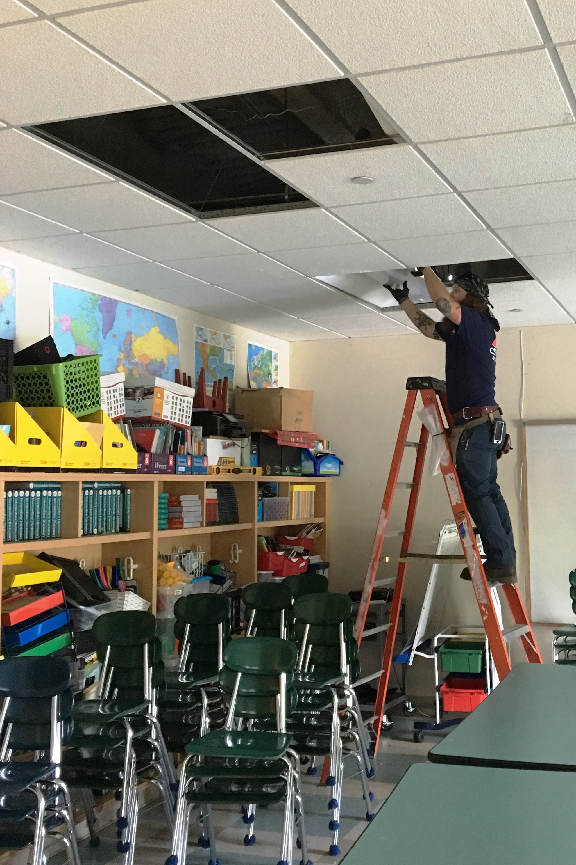 Zap Electric electrician working to replace CFL with LED lights